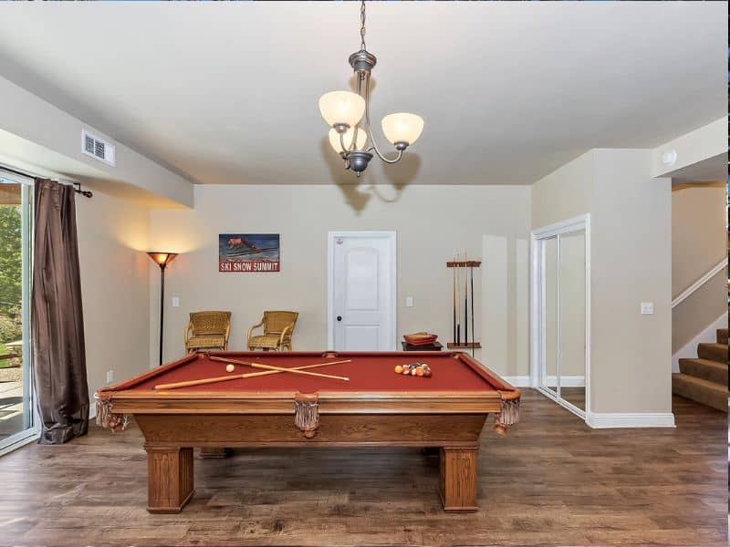 Recreational room in a Big Bear cabin rental with a pool table and warm lighting.