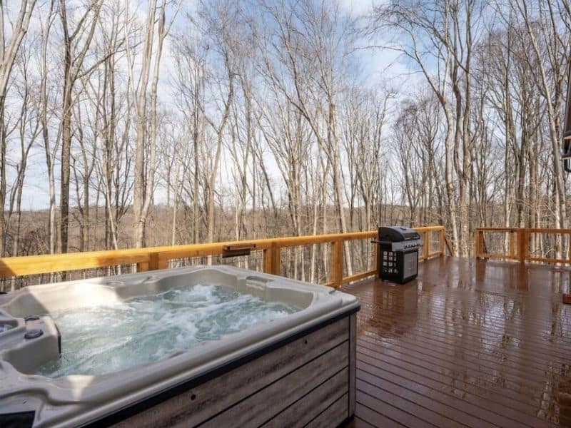 A cozy hot tub nestled on a secluded deck in the peaceful woods of Hocking Hills.