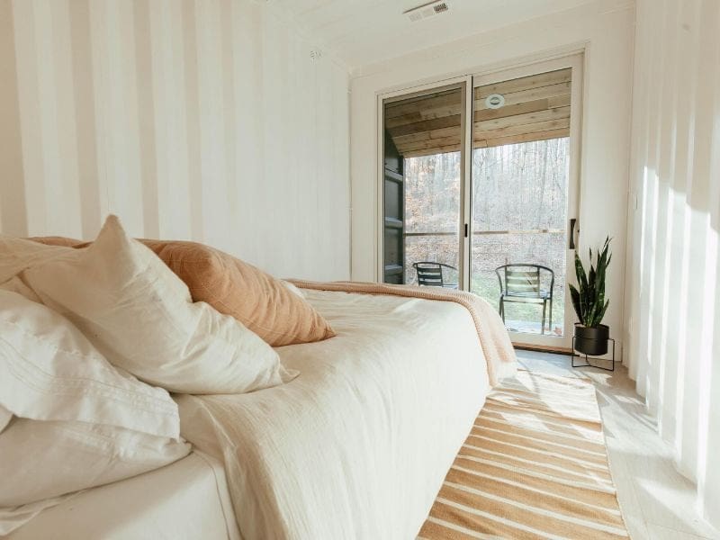 A bedroom with a sliding glass door.