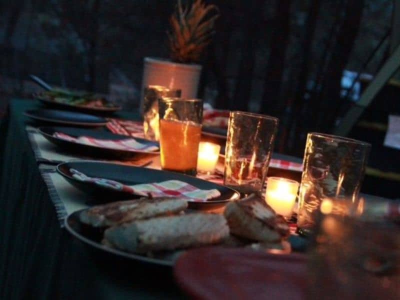 Candlelit dinner setup by Arizona Luxury Expeditions, offering a warm and intimate dining atmosphere.