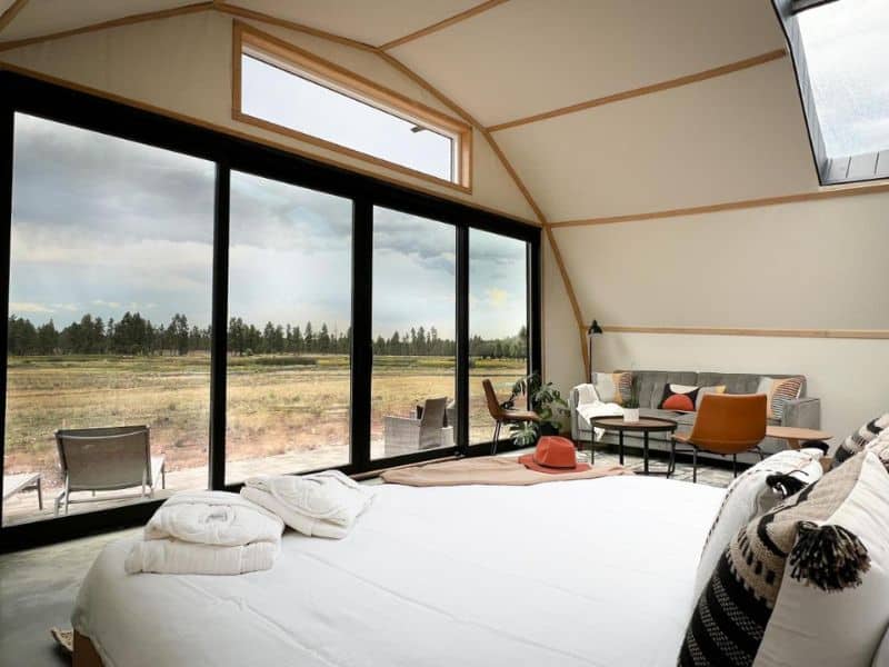 Inside a Backland glamping tent suite with floor-to-ceiling windows offering panoramic views near Williams, not far from the Grand Canyon.