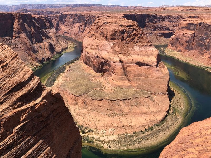 Aerial view of Horseshoe Bend in Page, Arizona, showing the Colorado River winding through the canyon, an essential stop on an LA to Grand Canyon Road Trip.