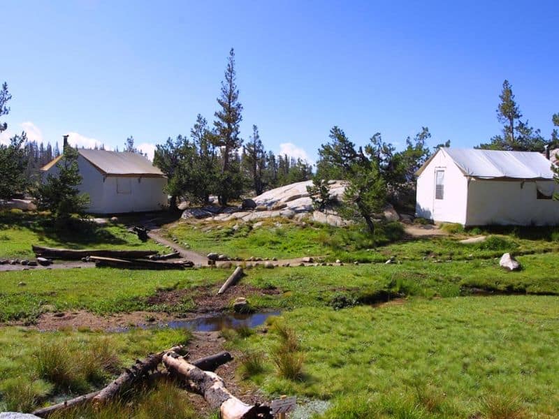 Yosemite High Sierra Camp nestled in a lush meadow, offering a remote glamping / slackpacking experience in the heart of the national park.