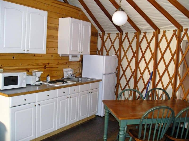Inside a yurt near Yosemite, featuring a kitchenette and dining table.