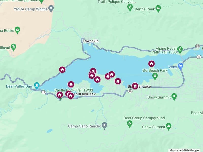 Map of Big Bear Lake area showing various locations of lakefront cabin rentals, marked with purple icons around the lake, particularly dense on the southern shore near Boulder Bay and Ski Beach Park.