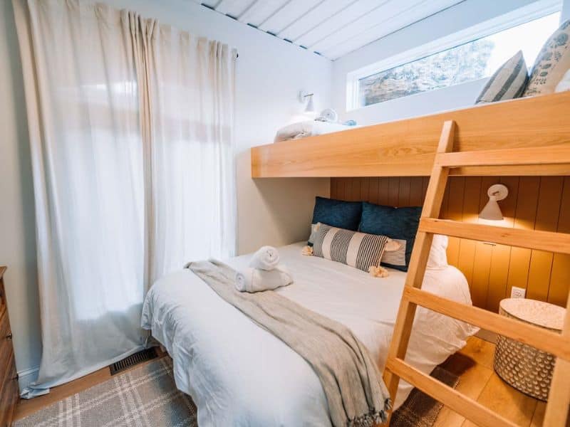 Compact yet inviting bedroom with a bunk bed design in The Overlook, a Hocking Hills container home.