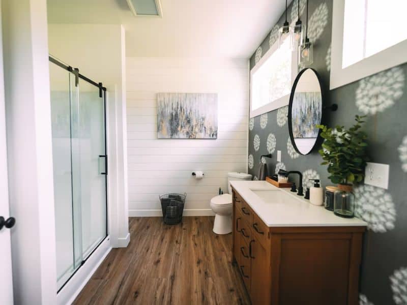 Bright bathroom with a walk-in shower and wall decor in The Silo, a grain silo container cabin located in Hocking Hills.